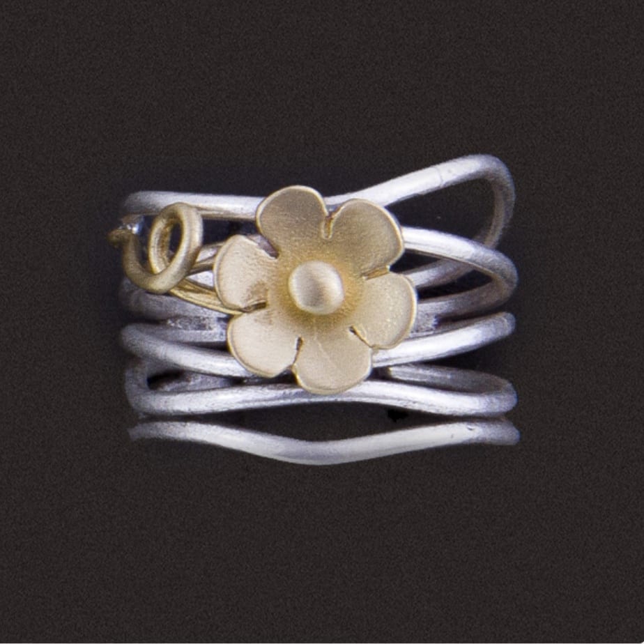 Silver ring with gold flower design